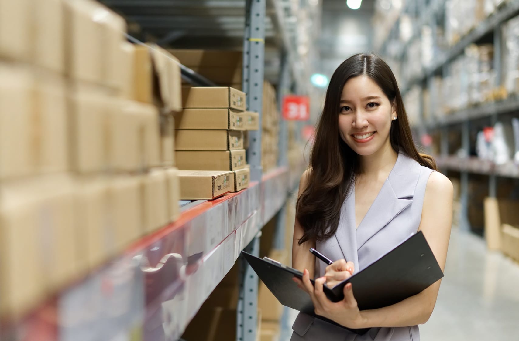 Image - Asian woman working in store warehouse.